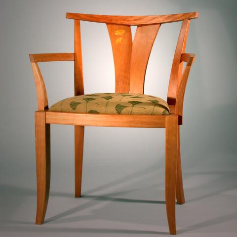 Dining chair in cherry with a cushioned seat