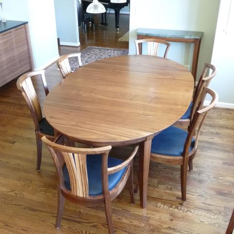 Walnut Medium Grande Laurel Dining Table shown with Neo chairs