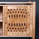 Intricately carved cabinet door in curly maple